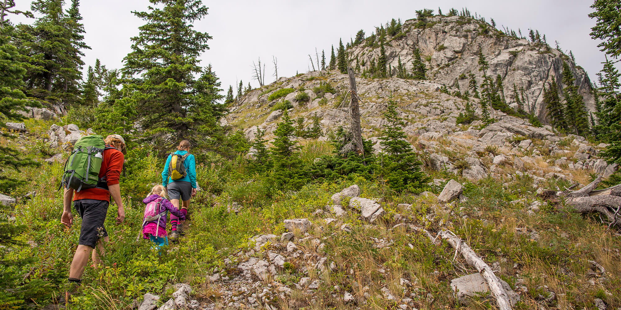 A man, woman, and child hiking in Fernie, BC. 